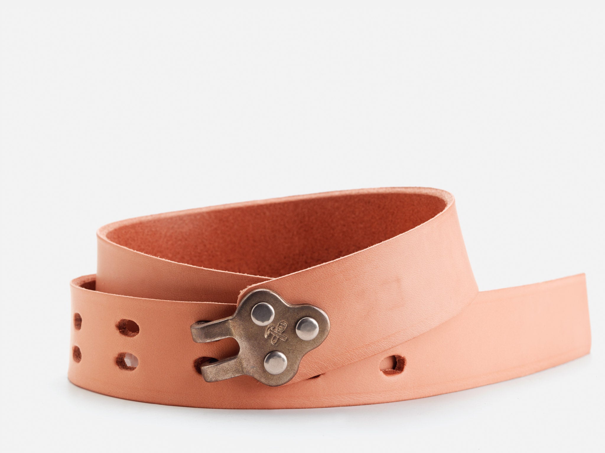 A rolled-up tan leather belt featuring a unique metal buckle shaped like a wind-up key, with multiple adjustment holes visible.